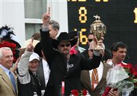 Trainer Bennie Woolley celebrates the Kentucky Derby win by Mine That Bird