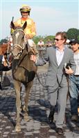 Celebrity chef Bobby Flay leading Her Smile into the winner’s circle at Belmont Park. The filly’s Prioress victory marked Flay’s first Grade 1 win as an owner. 