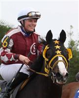 Anna is all smiles coming back to the Winner's Circle on her first Fair Grounds winner, Money Hill. 12-04-09