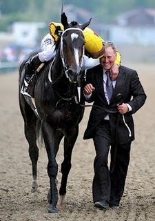 Calvin Borel hugs assistant Trainer Scott Blasi after Rachel Alexandra wins the Preakness