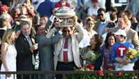 Owner K. K. Jayaraman and his wife celebrate Summer Bird's Belmont win with trainer Tim Ice, jockey Kent Desormeaux and NY Governor Patterson